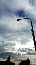 Low angle view of building against cloudy sky