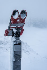 Snow-covered coin operated binoculars, oberwiesenthal germany.