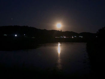 Scenic view of lake against sky at night