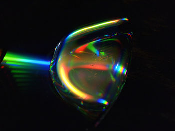 Close-up of illuminated bubbles over black background