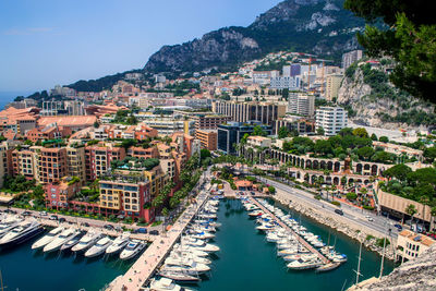 High angle view of buildings by sea against sky