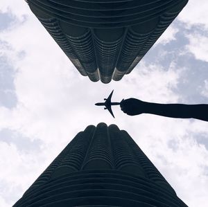 Low angle view of buildings against cloudy sky