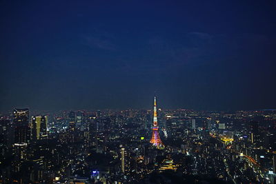 Illuminated buildings in city at night. view over tokyo tower  from mori tower, roppongi hills