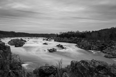 Scenic view of waterfall against sky