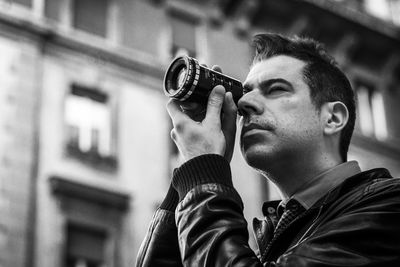 Portrait of young man photographing