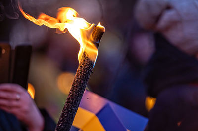 Ukrainian flags, candles and torches in the hands of protesters at the rally stand with ukraine