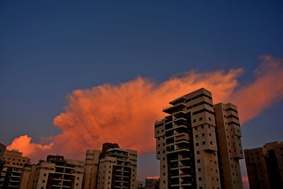 Low angle view of buildings against sky during sunset
