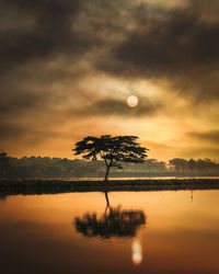 Scenic view of lake against sky during sunset