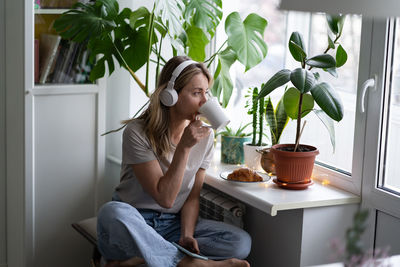 Woman drinking coffee at home