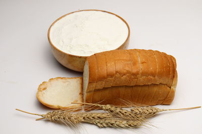 High angle view of bread on table against white background