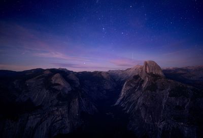 Scenic view of mountains against sky at night