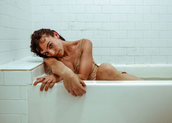 Portrait of woman sitting in bathtub