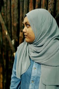 Young woman wearing hijab looking away outdoors