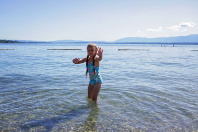 Portrait of smiling girl standing in lake