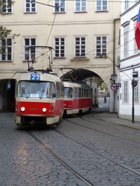 Train on street by buildings in city