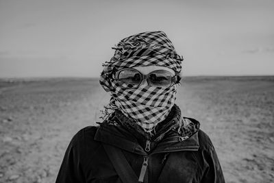 Portrait of woman wearing sunglasses against sky and turban