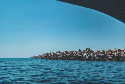 Scenic view of sea against clear blue sky