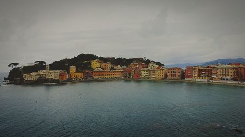 Scenic view of sea and buildings against sky