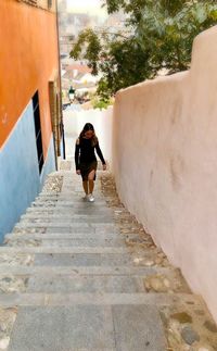 High angle view of woman climbing steps