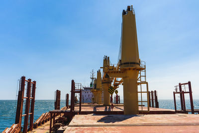 Offshore platform in sea against sky