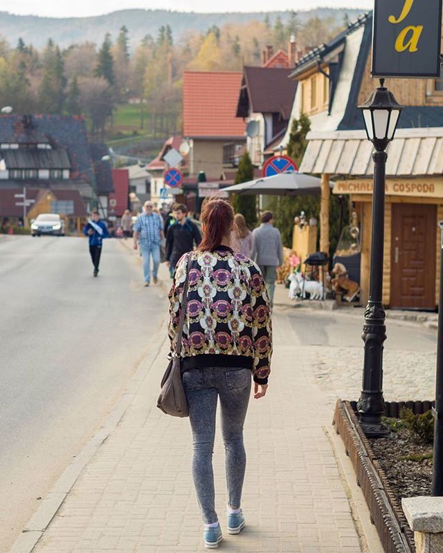 building exterior, lifestyles, architecture, built structure, walking, rear view, full length, person, street, leisure activity, men, casual clothing, city life, city, cobblestone, standing, day, outdoors