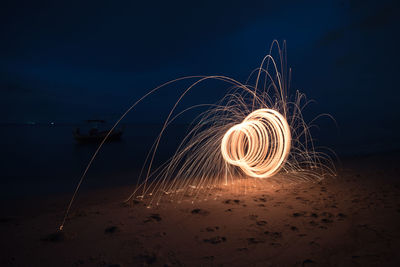 Wire wool spinning at beach during night