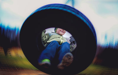 Close-up view of boy on swing