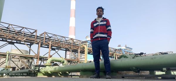 Low angle view of man standing against sky