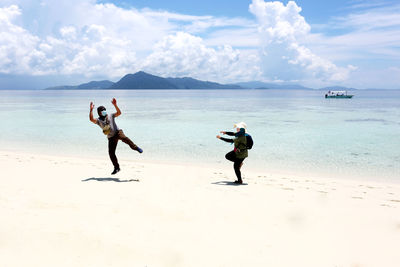 People on beach against sky