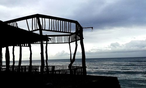 Pier on sea at sunset