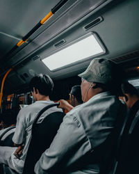 Rear view of people traveling in train