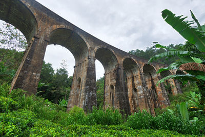 Low angle view of arch bridge against sky