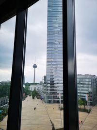 Buildings in city seen through glass window