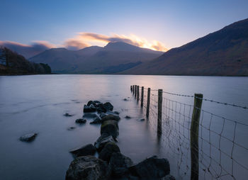 Scenic view of lake against sky during sunset