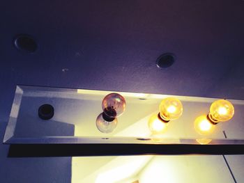 Low angle view of illuminated ceiling