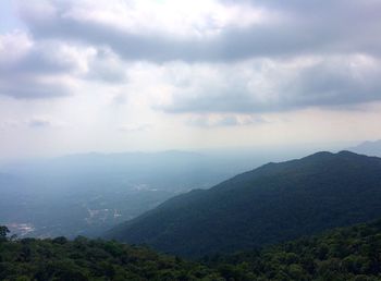 Scenic view of mountains against cloudy sky