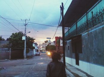 Man walking on road against sky