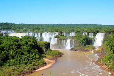 River amidst trees against clear sky