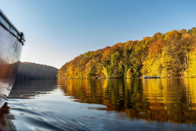 Scenic view of lake against clear blue sky