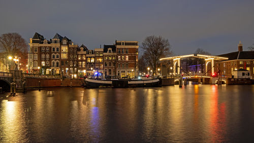 City scenic from amsterdam at the amstel in the netherlands at night