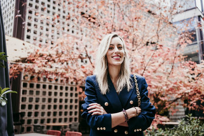 Portrait of smiling young woman standing outdoors