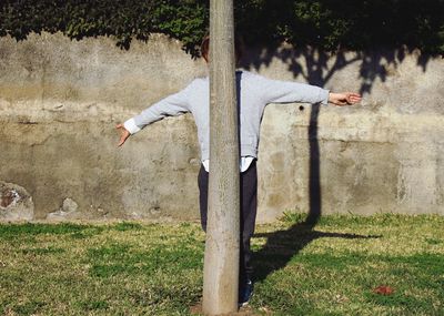 Man standing by tree on field