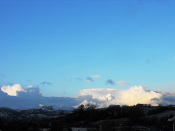 Scenic view of landscape against blue sky