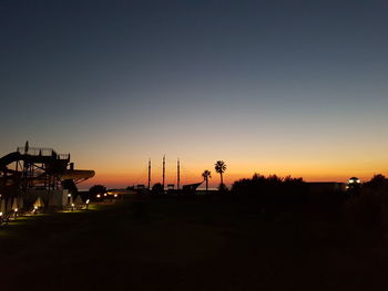 Silhouette of lamp post against sky at sunset