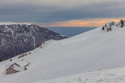 Scenic view of snow covered mountains against sky