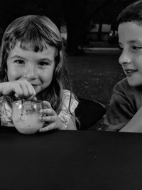 Portrait of a boy with ice cream on table