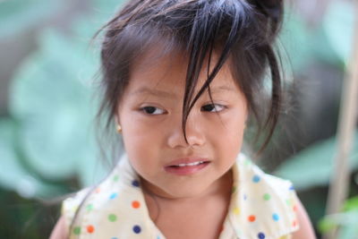 Close-up of cute girl looking away