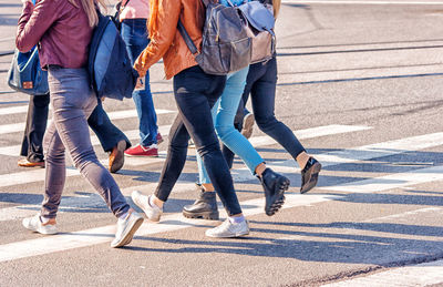 Low section of people crossing road in city