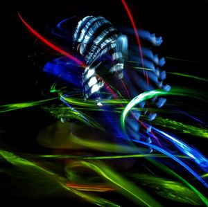 Close-up of light painting against black background