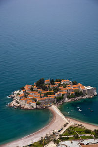 High angle view of buildings in town amidst sea